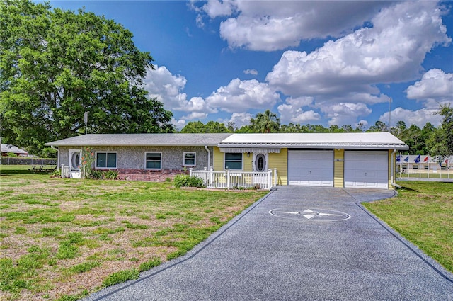 ranch-style house with a garage, a front yard, and driveway
