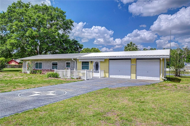 single story home with aphalt driveway, a front lawn, and an attached garage