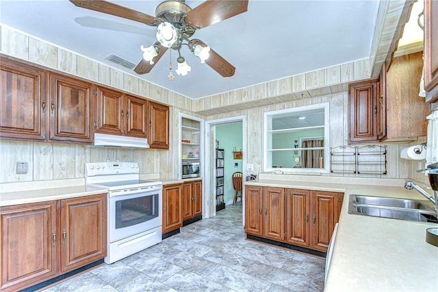 kitchen with light countertops, ceiling fan, electric stove, under cabinet range hood, and stainless steel microwave