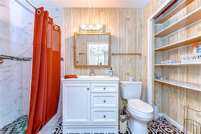 bathroom with wood walls, vanity, a tile shower, and toilet