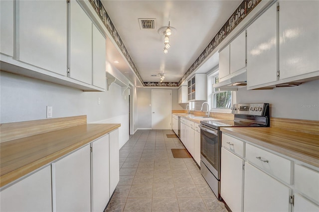 kitchen with light countertops, white cabinetry, under cabinet range hood, visible vents, and appliances with stainless steel finishes