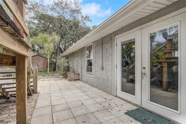 view of patio / terrace with an outdoor structure and a storage unit