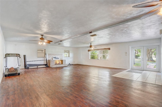 unfurnished living room with wood finished floors and a ceiling fan