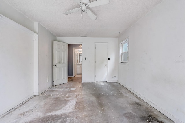 interior space with visible vents, ceiling fan, a textured ceiling, and unfinished concrete floors