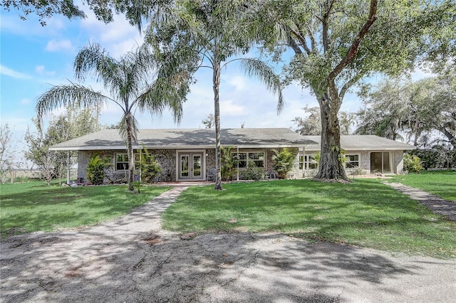 view of front of house with a front yard and french doors
