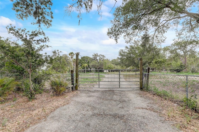 view of gate with fence