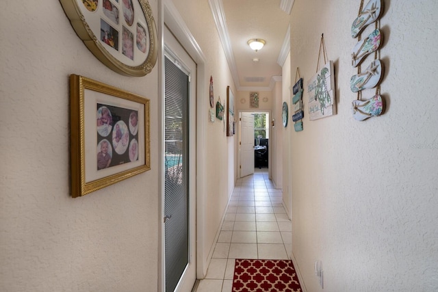 hall featuring light tile patterned flooring and crown molding