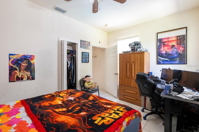 bedroom featuring light tile patterned flooring, a desk, and ceiling fan