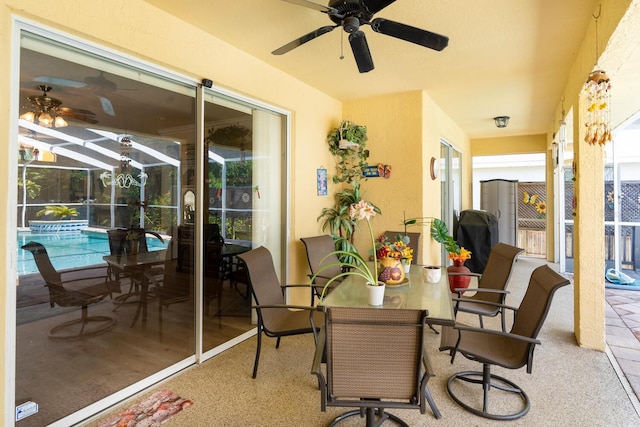view of patio / terrace with ceiling fan, an outdoor pool, a lanai, and outdoor dining area