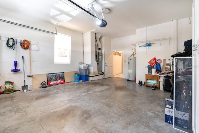garage with water heater, a garage door opener, and concrete block wall
