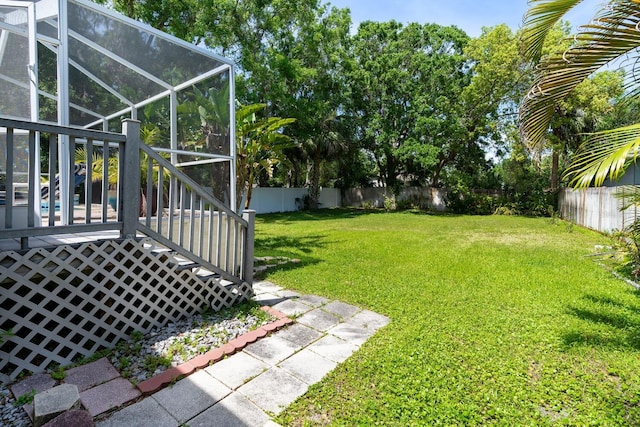 view of yard with glass enclosure