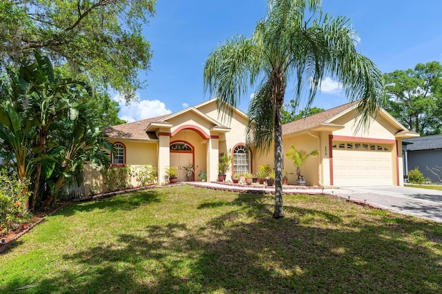 mediterranean / spanish-style house with stucco siding, an attached garage, concrete driveway, and a front lawn