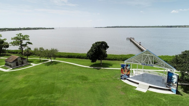 view of home's community featuring a water view and a lawn
