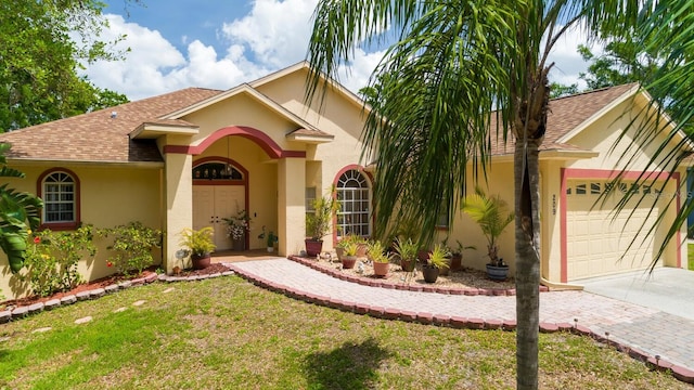 mediterranean / spanish-style home featuring a garage, stucco siding, driveway, and a shingled roof