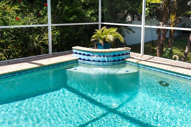 swimming pool featuring fence and a lanai