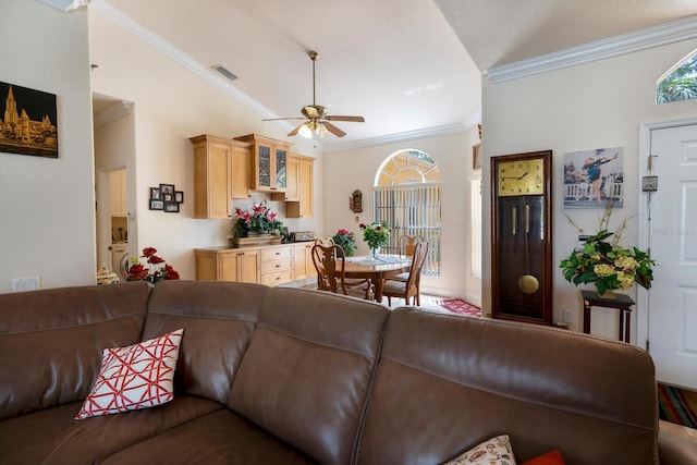 living area with ornamental molding, a ceiling fan, and washer / dryer