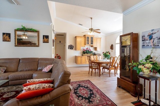 living area with a ceiling fan, light wood-style flooring, lofted ceiling, crown molding, and baseboards