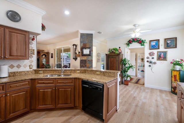 kitchen featuring black dishwasher, a sink, a ceiling fan, brown cabinetry, and ornamental molding