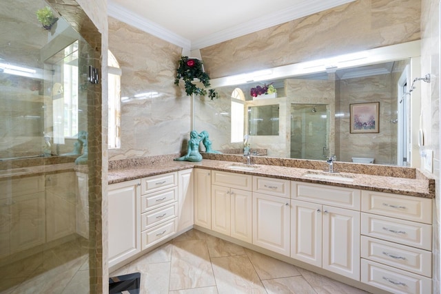 bathroom featuring crown molding, a shower stall, double vanity, and marble finish flooring