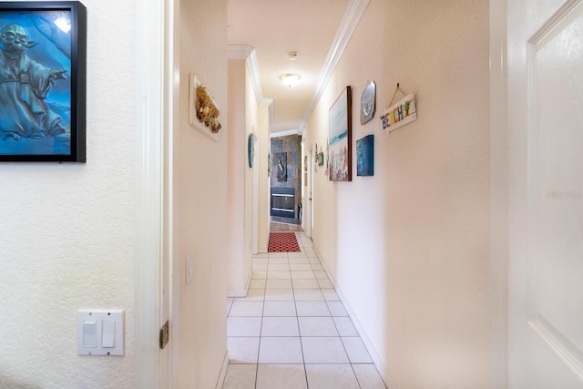 hall with crown molding, light tile patterned floors, and baseboards