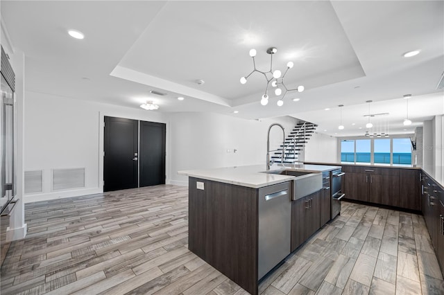 19816 Gulf Blvd Unit 602, Indian Shores, FL 33785 - kitchen featuring dishwasher, a tray ceiling, dark brown cabinetry, and a notable chandelier
