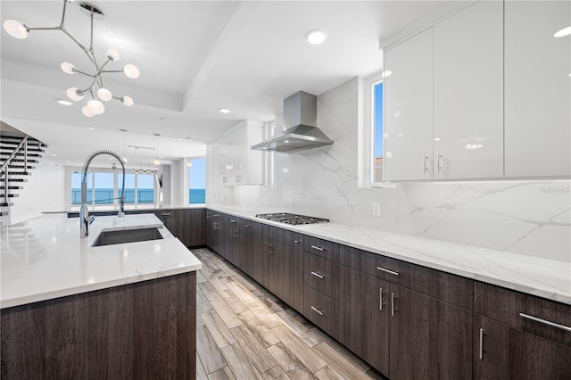 19816 Gulf Blvd Unit 602, Indian Shores, FL 33785 - kitchen featuring wall chimney exhaust hood, modern cabinets, and stainless steel gas stovetop