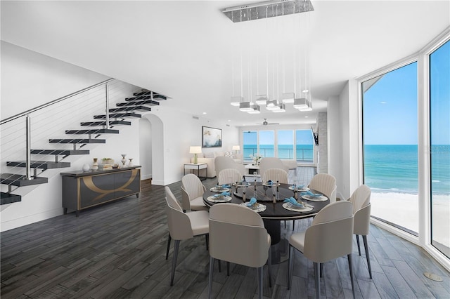 19816 Gulf Blvd Unit 602, Indian Shores, FL 33785 - dining space with wood finished floors, a water view, arched walkways, baseboards, and ceiling fan