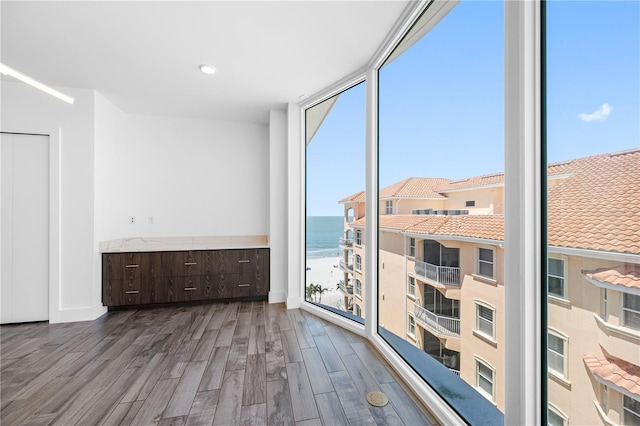 19816 Gulf Blvd Unit 602, Indian Shores, FL 33785 - unfurnished room with wood finished floors, a water view, and a wall of windows