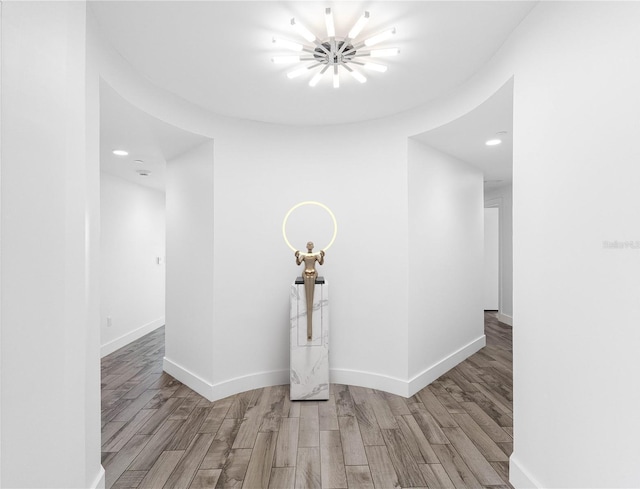 19816 Gulf Blvd Unit 602, Indian Shores, FL 33785 - hall featuring baseboards, a notable chandelier, wood finished floors, and recessed lighting