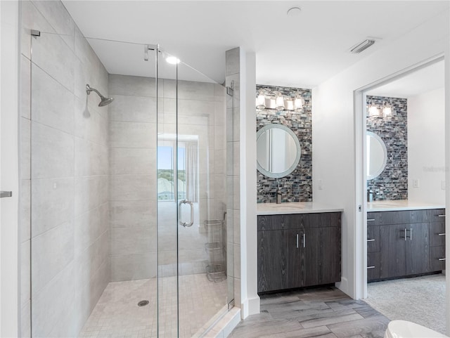 19816 Gulf Blvd Unit 602, Indian Shores, FL 33785 - full bathroom featuring a shower stall, wood finished floors, vanity, backsplash, and visible vents