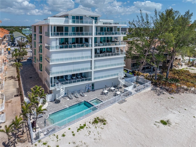19816 Gulf Blvd Unit 602, Indian Shores, FL 33785 - view of building exterior with a fenced backyard and a community pool
