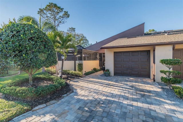 5010 Umber Way N, Tampa, FL 33624 - exterior space featuring a garage, decorative driveway, and stucco siding