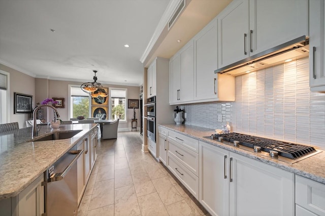 145 Belleview Blvd Unit 201, Belleair, FL 33756 - kitchen with tasteful backsplash, crown molding, under cabinet range hood, stainless steel appliances, and a sink