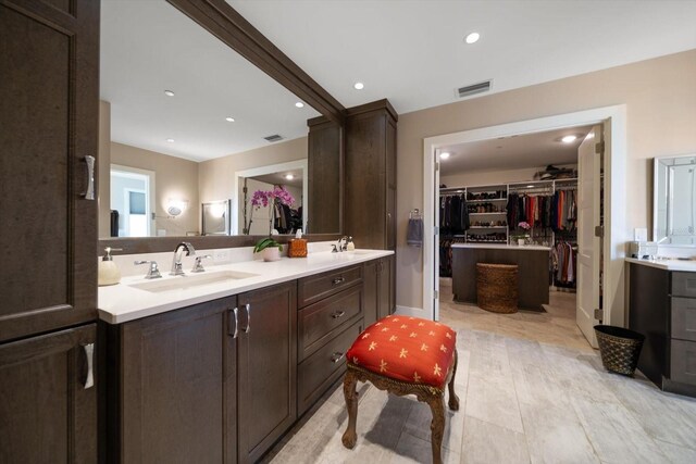 145 Belleview Blvd Unit 201, Belleair, FL 33756 - bathroom with double vanity, recessed lighting, a walk in closet, visible vents, and a sink