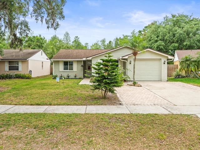 16116 Manorwood Cir, Tampa, FL 33624 - single story home featuring brick siding, an attached garage, driveway, and a front lawn