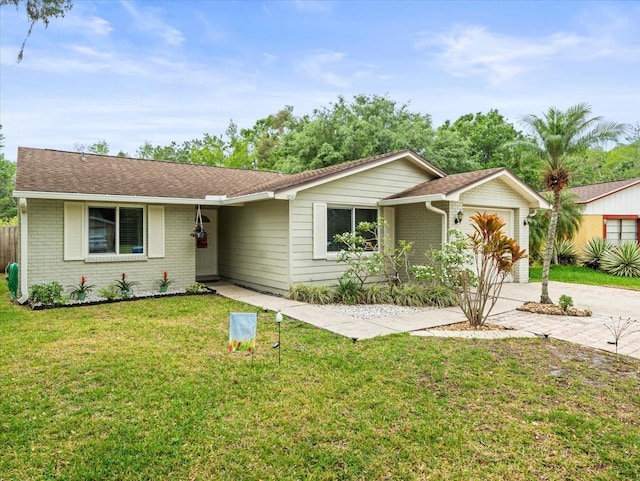 16116 Manorwood Cir, Tampa, FL 33624 - single story home featuring a front lawn, brick siding, an attached garage, a shingled roof, and concrete driveway