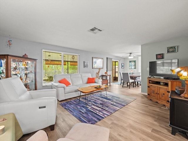 16116 Manorwood Cir, Tampa, FL 33624 - living room with light wood-type flooring, ceiling fan, and visible vents