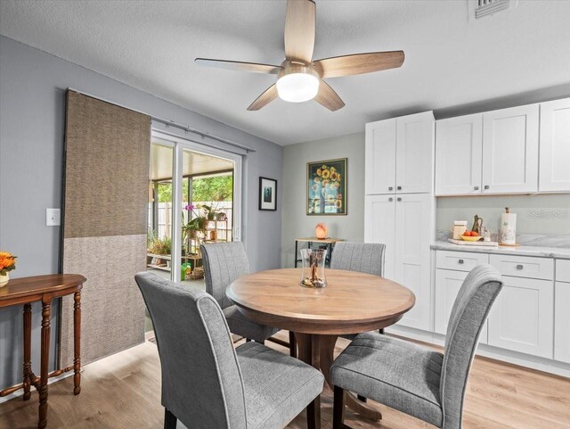 16116 Manorwood Cir, Tampa, FL 33624 - dining space with light wood-type flooring, a ceiling fan, and visible vents