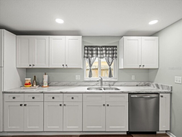 16116 Manorwood Cir, Tampa, FL 33624 - kitchen featuring stainless steel dishwasher, a sink, white cabinetry, and light stone countertops