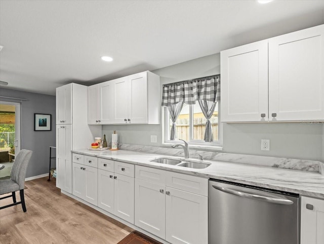 16116 Manorwood Cir, Tampa, FL 33624 - kitchen with stainless steel dishwasher, a wealth of natural light, white cabinets, and a sink