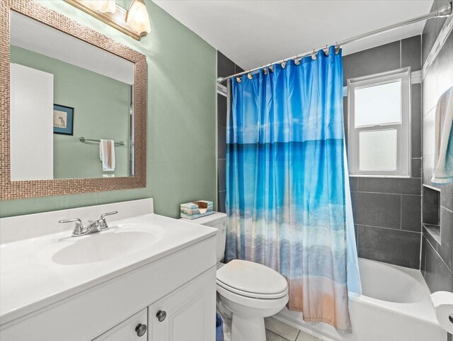 16116 Manorwood Cir, Tampa, FL 33624 - full bathroom with toilet, shower / bath combo with shower curtain, tile patterned flooring, and vanity