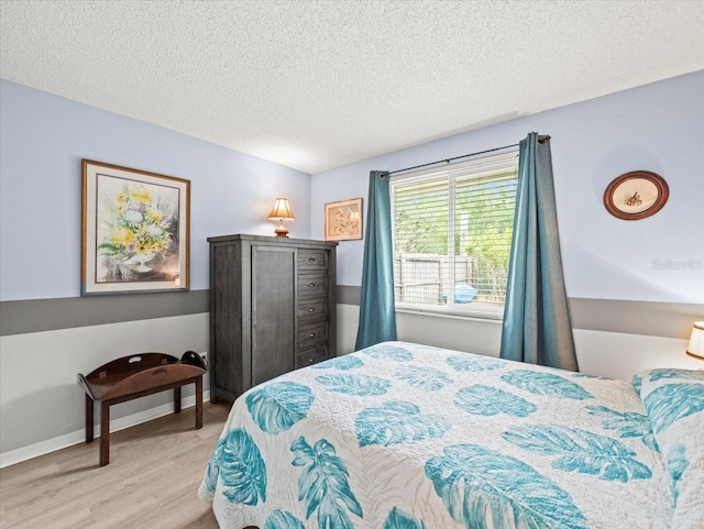 16116 Manorwood Cir, Tampa, FL 33624 - bedroom with a textured ceiling, baseboards, and wood finished floors