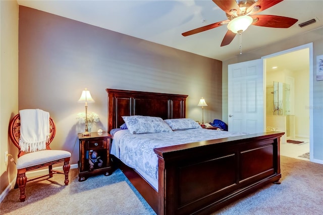 bedroom featuring ensuite bathroom, baseboards, visible vents, carpet, and a ceiling fan