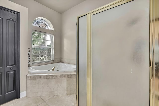 full bathroom featuring a shower stall, tile patterned flooring, and a bath