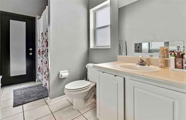 bathroom featuring vanity, tile patterned flooring, toilet, a shower with shower curtain, and baseboards