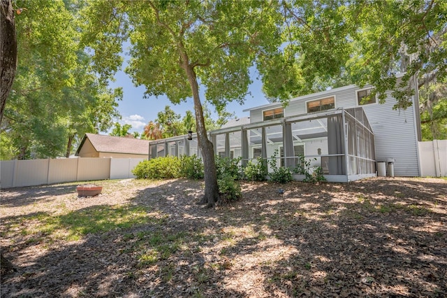 1916 River Crossing Dr, Valrico, FL 33596 - view of yard with a fenced backyard, a sunroom, and glass enclosure