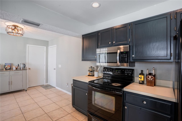 1916 River Crossing Dr, Valrico, FL 33596 - kitchen featuring stainless steel microwave, black electric range oven, visible vents, and light countertops