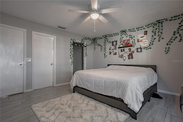 1916 River Crossing Dr, Valrico, FL 33596 - bedroom featuring baseboards, visible vents, a textured ceiling, and wood tiled floor
