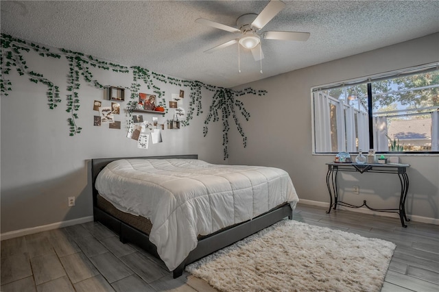 1916 River Crossing Dr, Valrico, FL 33596 - bedroom featuring a textured ceiling, wood finish floors, a ceiling fan, and baseboards