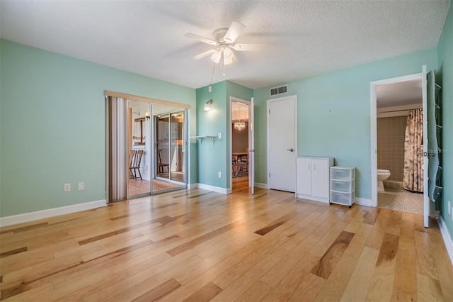 unfurnished bedroom with baseboards, access to outside, light wood-type flooring, and visible vents